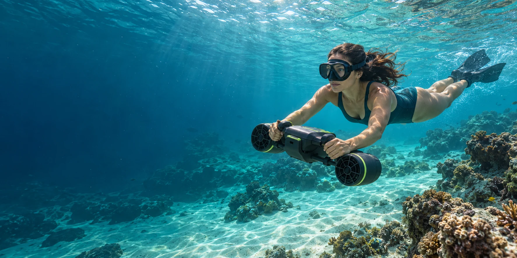 Swimmer exploring clear turquoise water with a sea scooter