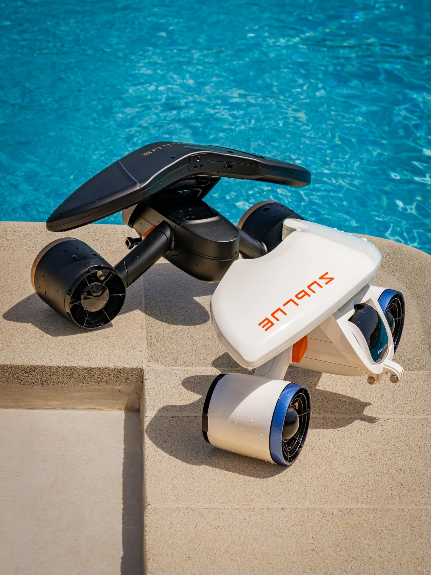 White and black SUBLUE MixPro sea scooters beside a pool